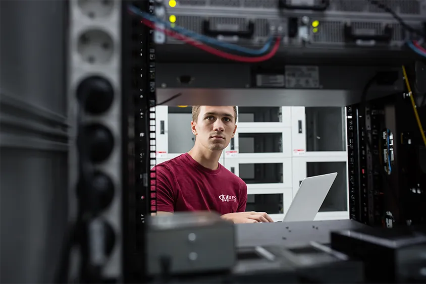 Miles IT engineer working in a server room