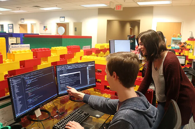 Miles IT team members working together at their computers